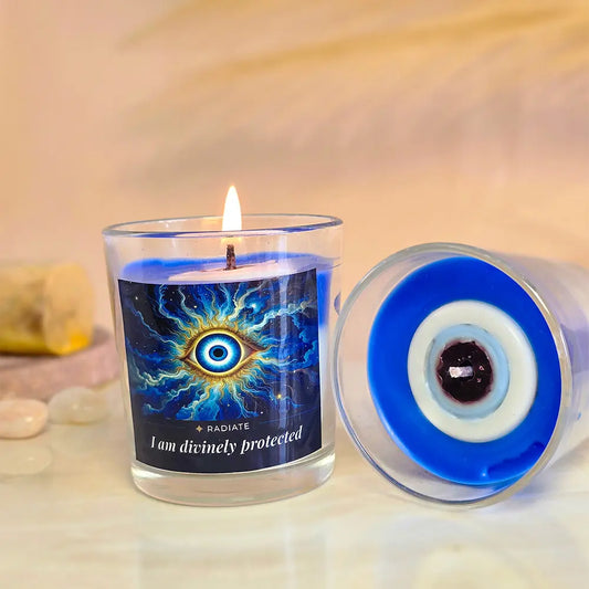Radiate's evil eye protected soy wax scented candle with scents of Jasmine, Sandalwood and Frankincense or Loban on a marble table with a sandalwood stick blurred in background.