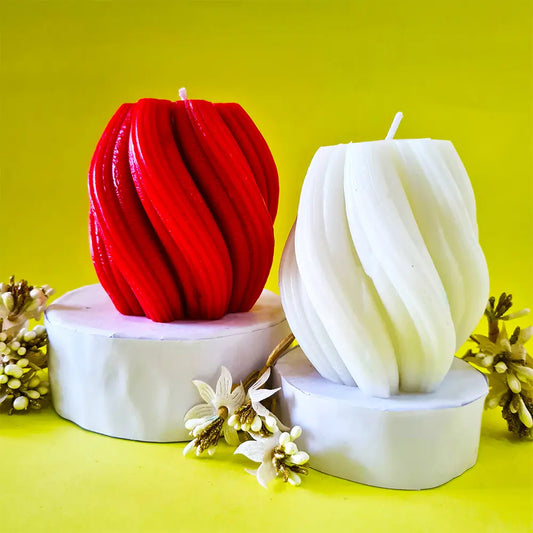 Red and white spiral swirl waves scented pillar candles on a yellow background with floral elements.