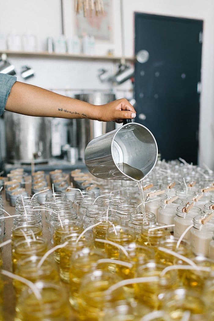 Candle making process - pouring wax into containers