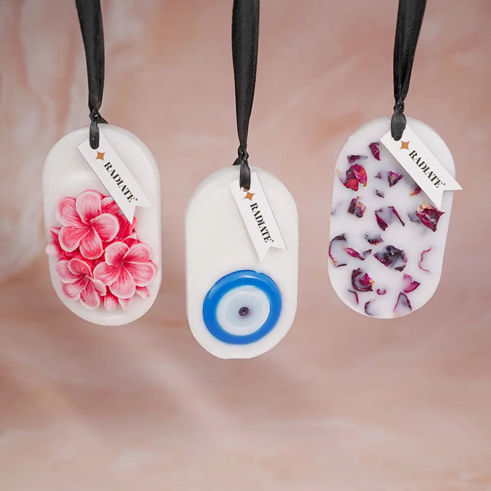 Radiate's pack of three wax tablets with floral design, eye eye design, and rose petal designs on a blurred background.