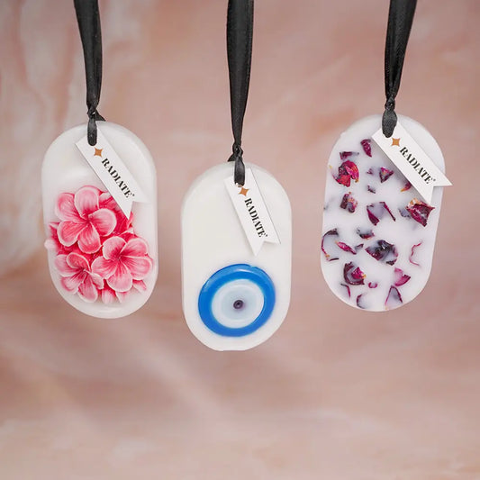 Radiate's pack of three wax tablets with floral design, eye eye design, and rose petal designs on a blurred background.