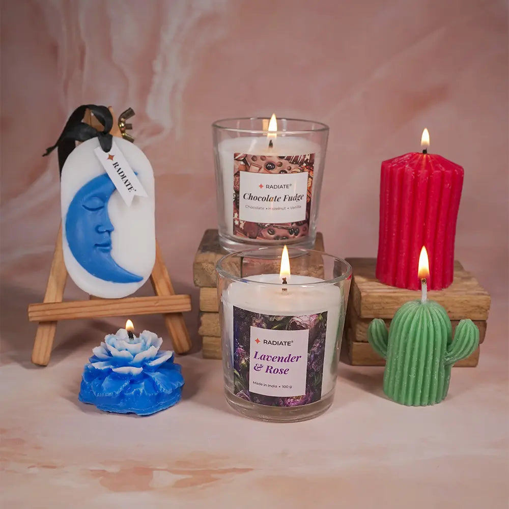 Radiate's luxury gift box containing Chocolate fudge scented candle, Lavender rose scented candle, Red ribbed pillar candle, cactus shaped pillar candle, peony rose candle and moon wax sachet.