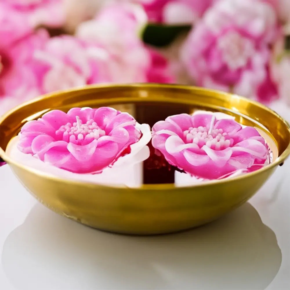 Radiate's pink lotus flower-shaped candles in a gold bowl with pink floral background