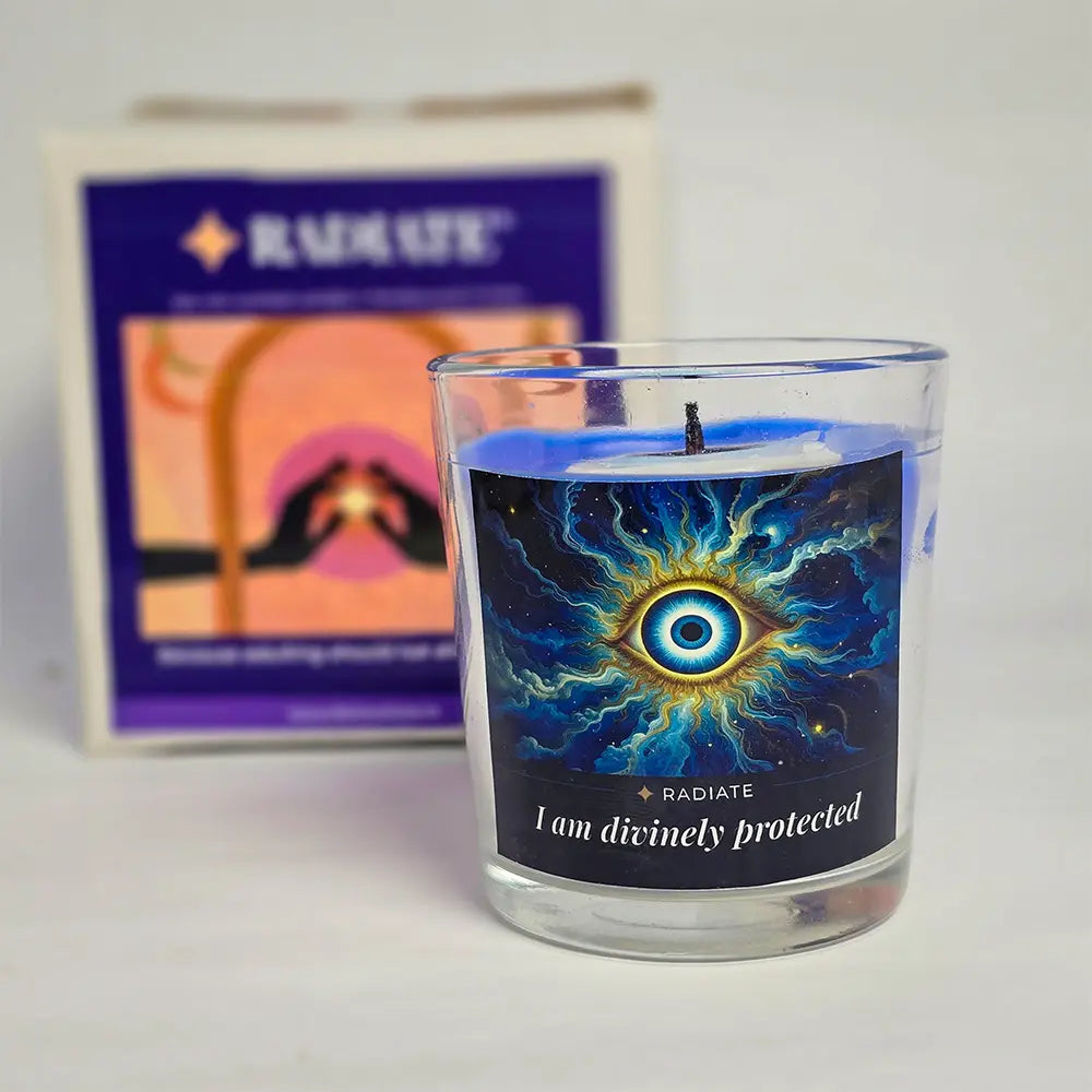 Evil eye protection scented soy wax candle with it's packaging box blurred in background.