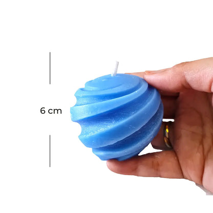 Blue spiral candle held by a hand with a measurement label indicating 6 cm.