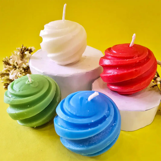Colorful spiral swirl ball candles on a yellow background