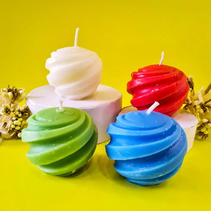 Colorful spiral swirl ball pillar candles on a yellow background